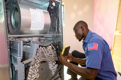 man working on a heating and cooling system